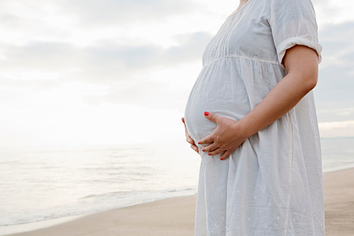 a pregnant woman on the beach